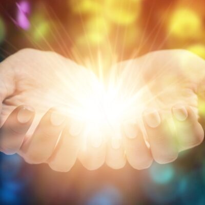 Female,Hands,With,Shining,Energy,On,Color,Background