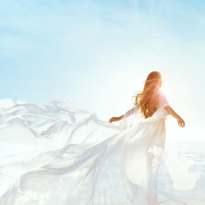 Woman,On,Sunny,Sea,Beach,In,White,Fluttering,Dress,,Fashion